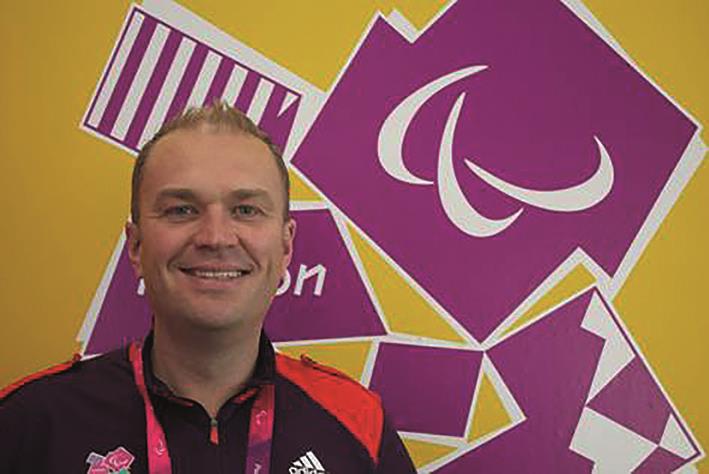 Mark Stuart standing in front of the 2012 Olympics logo