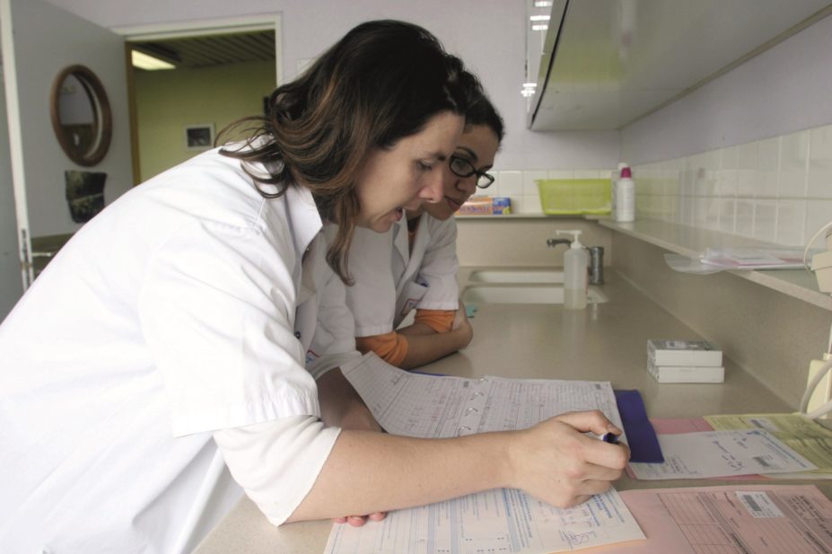 In order to qualify as an independent prescriber, pharmacists must be supervised by a designated medical practitioner. In the image, a pharmacist speaks with a general practitioner