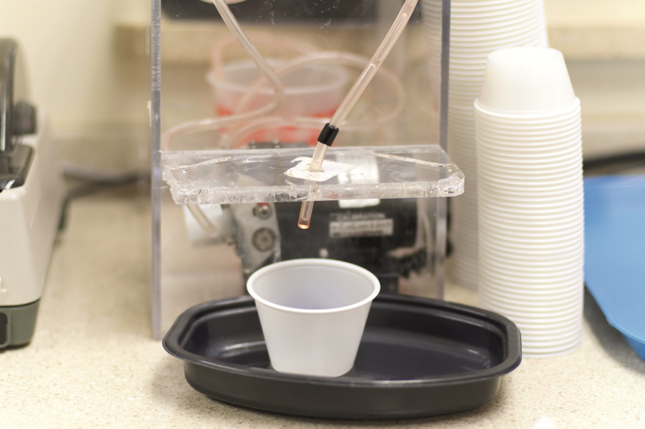 A plastic medication cup in a methadone dispenser
