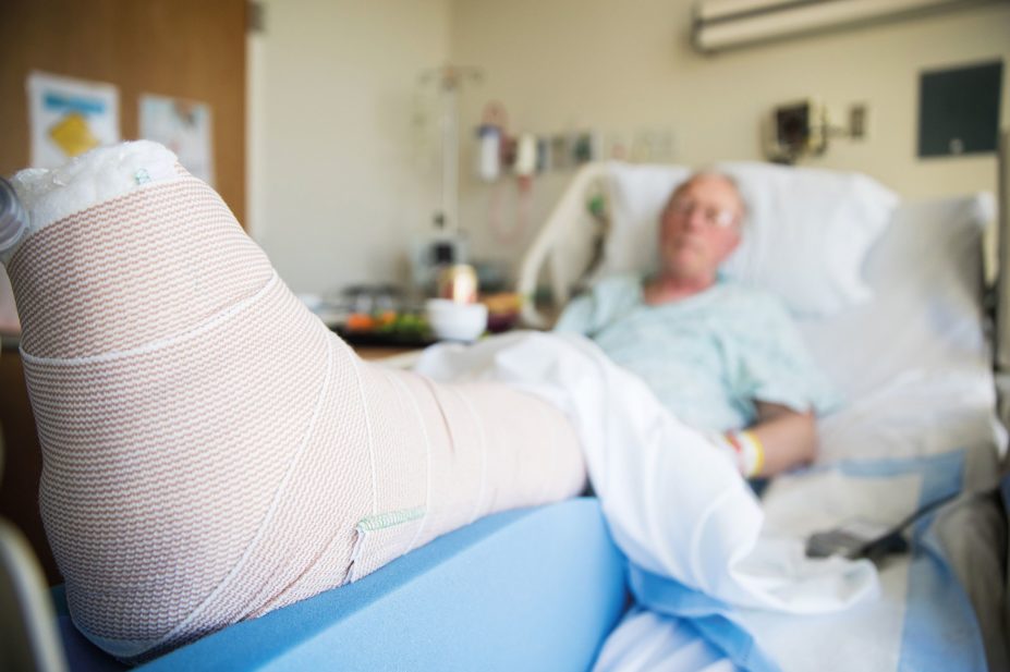 Elderly person with broken leg in hospital