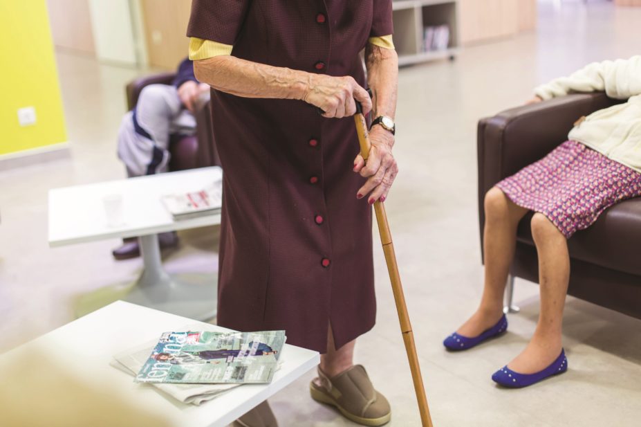 Older person with walking stick