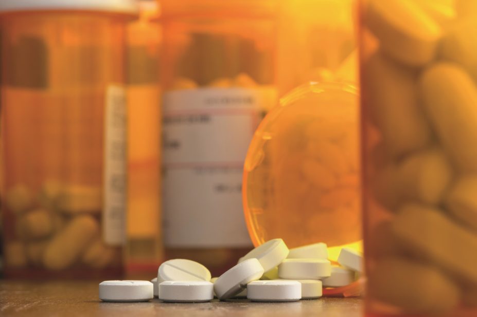 Patients with chronic pain who also have depression are more likely to be prescribed opioids, but evidence suggests that opioids can also increase the risk of developing depression. In the image, close-up of opioids and prescription bottles
