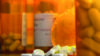 Opioids on table and in US medicine bottles