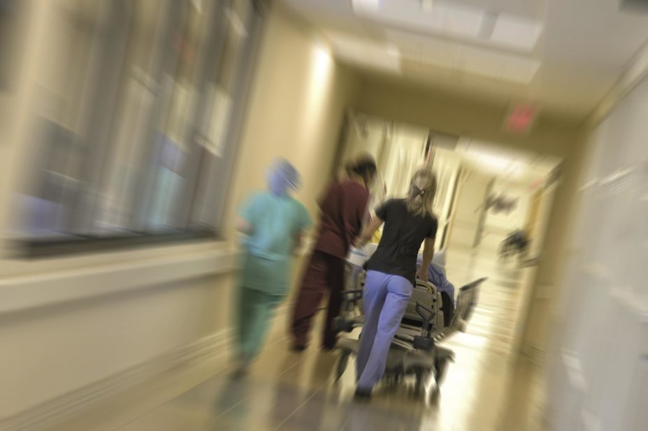 Blurred image of patient being rush by hospital staff to an emergency room