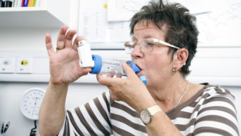 Female patient using an inhaler