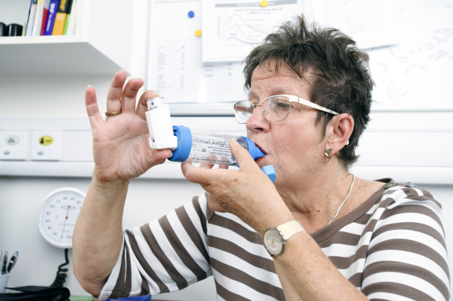 Female patient using an inhaler