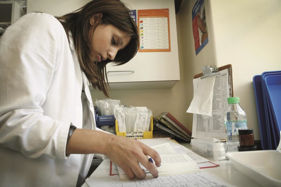 NHS pharmacists are reluctant to carry out research because of a lack of confidence, time and support as well as a belief that it is not part of their core work, according to a study. In the image, a busy pharmacist updates patient record