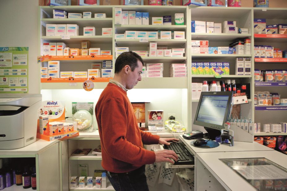 Pharmacist accessing patient record via computer