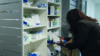 Pharmacist goes through prescription medicines in a pharmacy