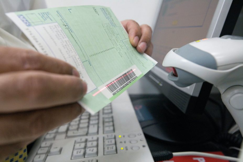 Pharmacist scanning prescription barcode