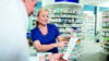 Pharmacist speaking with customer