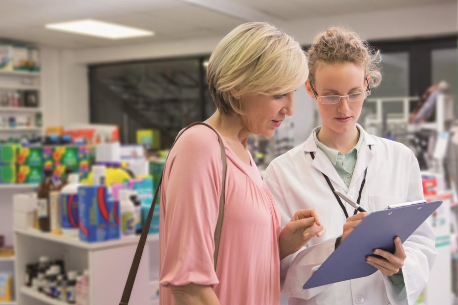 A pharmacist and customer discuss a survey in a pharmacy