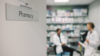 Pharmacists talking inside hospital a dispensary