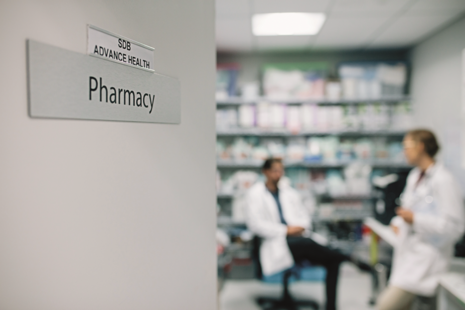 Pharmacists talking inside hospital a dispensary