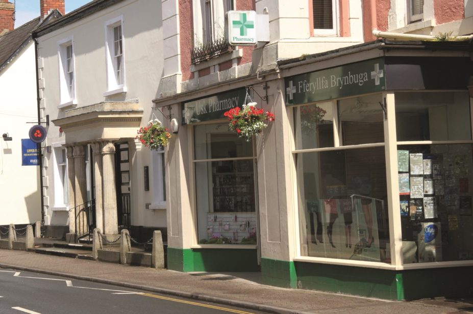 The £11m cost of introducing a common ailment scheme in Wales would be outweighed by savings made from reduced GP appointments. In the image, the storefront of a pharmacy in Usk Town Centre, Gwent, Wales