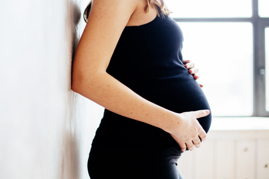 Pregnant lady holding abdomen