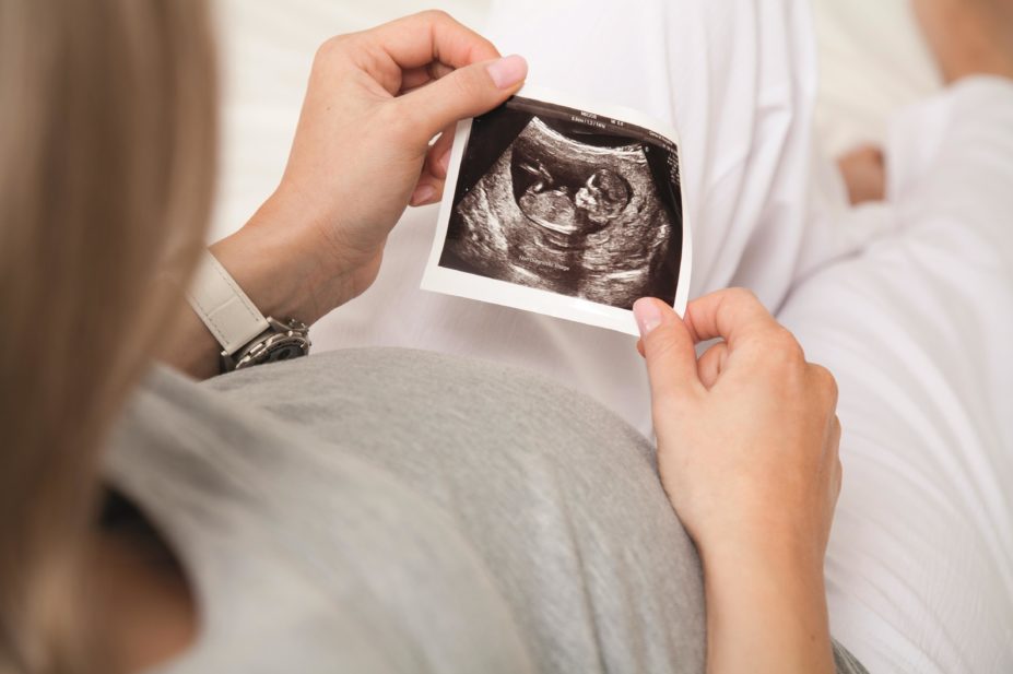 Pregnant women who have cancer do not need to have a termination because their treatment may not harm their developing baby, according to researchers. In the image, a pregnant woman looks at an ultrasound of her baby