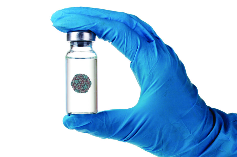 Hand holding vaccine bottle with rhinovirus vaccine (RV14)