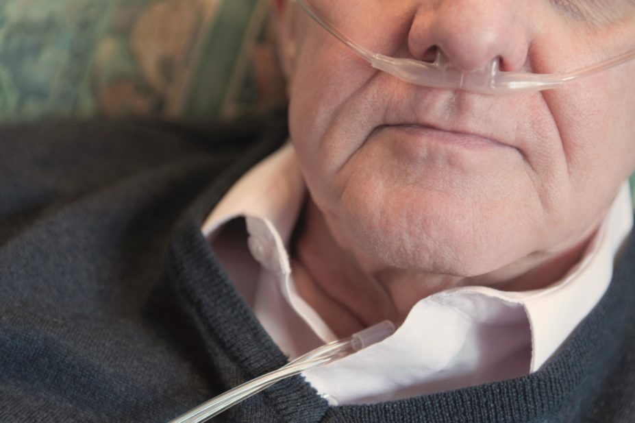 Use of inhaled corticosteroids in patients with chronic obstructive pulmonary disease (COPD) is associated with an increased risk of pneumonia. In the image, close up of a man using oxygen nasal tubes