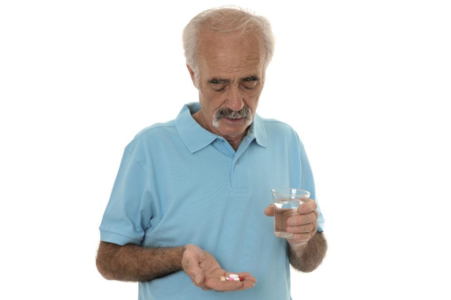 Senior man taking tablets