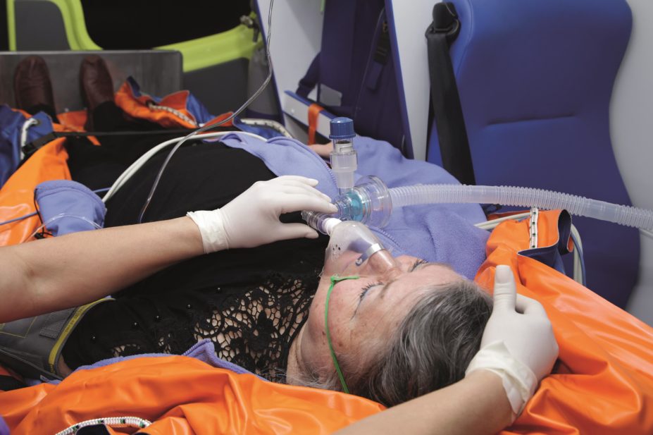 Senior woman receives emergency oxygen in an ambulance