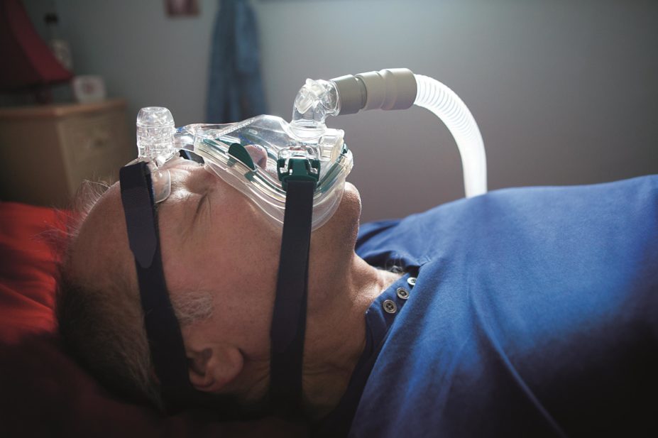 Selection of active treatments for sleep disorders mostly occurs in the absence of evidence-based protocols, with drug treatments recommended empirically. In the image, a man wears a CPAP mask to treat apnoea