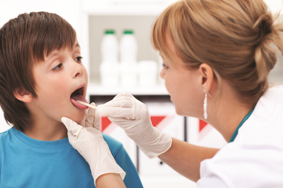 child being examined for sore throat