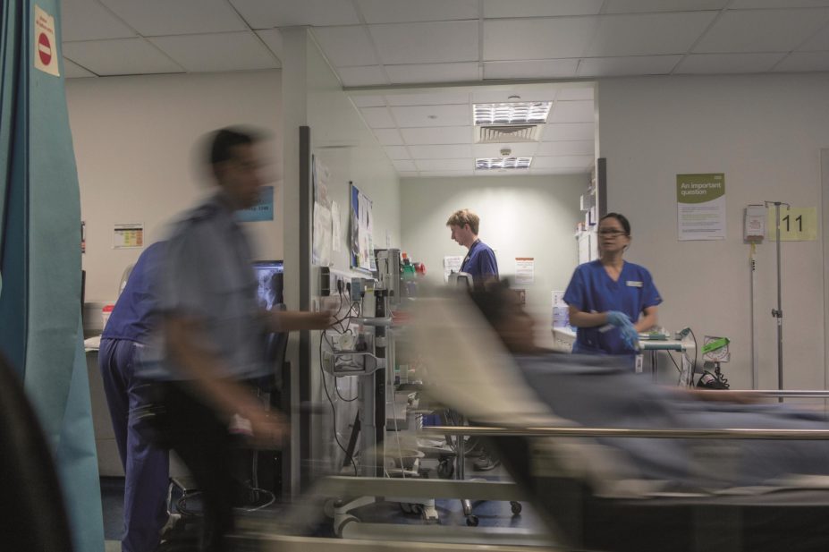 NHS foundation trusts in England are £445m in debt — £90m worse than expected — and facing one of their toughest financial years ever. In the image, busy hospital staff at an NHS Trust