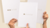 Image of hands holding up sheets of paper with 1-2 star rating