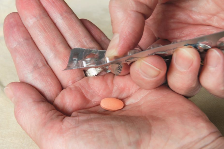Statins, which are prescribed to reduce cholesterol, have been found to reduce aggression in men, but to increase aggression in postmenopausal women. In the image, a woman drops a statin from a blister pack
