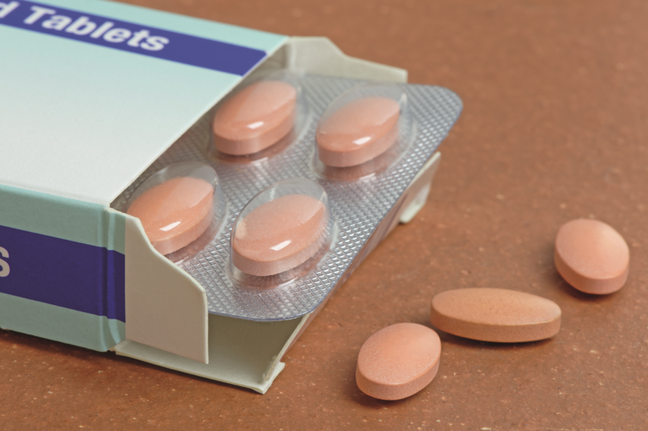Statin tablets next to a pill box