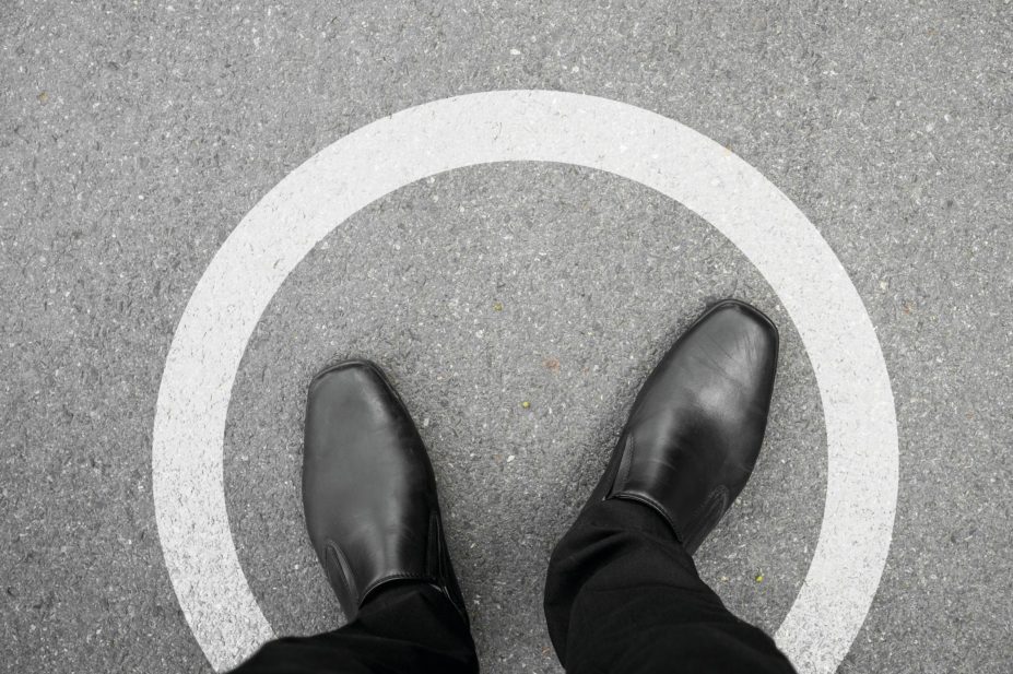 Close up of shoes of a standing man within a white circle