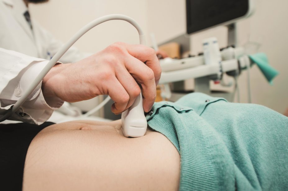 Doctor performs an ultrasound in early pregnancy