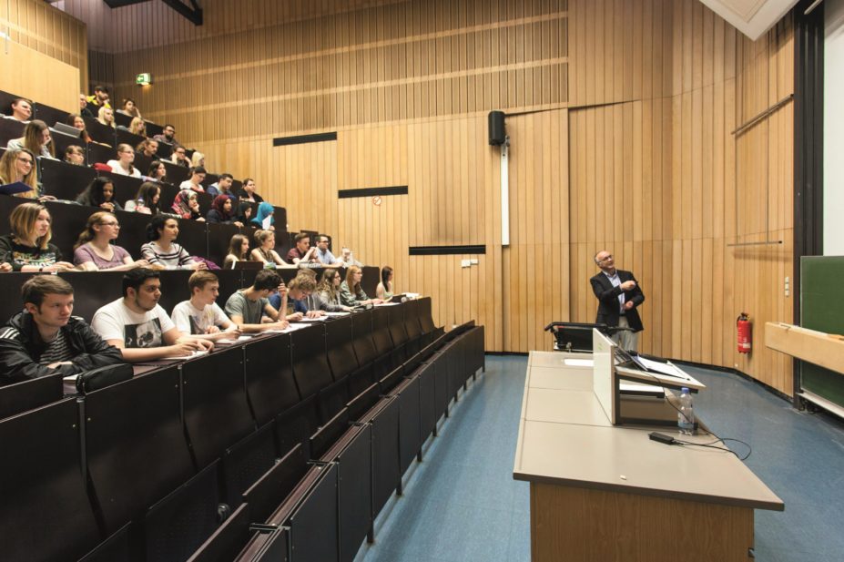 Lecturer in classroom full of students