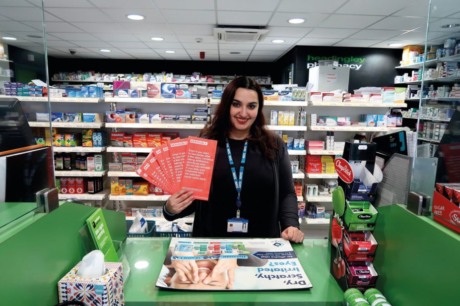Veronica Sanna from Headingley Pharmacy holds up the new red pharmacy bags