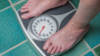 Person standing on bathroom scales