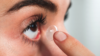 woman applying contact lens eye ss 17
