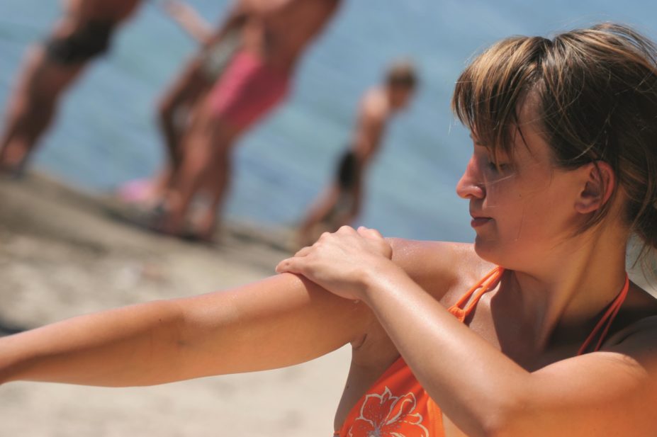 Two sunscreens, including one manufactured by Boots, have failed sun protection tests, according to research conducted by the consumer watchdog Which? In the image, a woman puts on sunscreen lotion while on the beach
