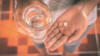 Woman holding paracetamol glass of water