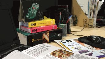 A writers' desk with different pharmacy-related magazines and publications