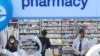 Pharmacists wearing masks while working in a pharmacy
