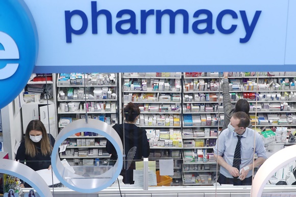 Pharmacists wearing masks while working in a pharmacy
