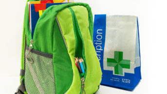child's backpack next to prescription bag