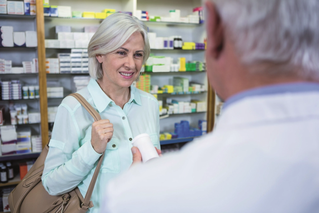 Senior woman speaks to a pharmacist about menopause