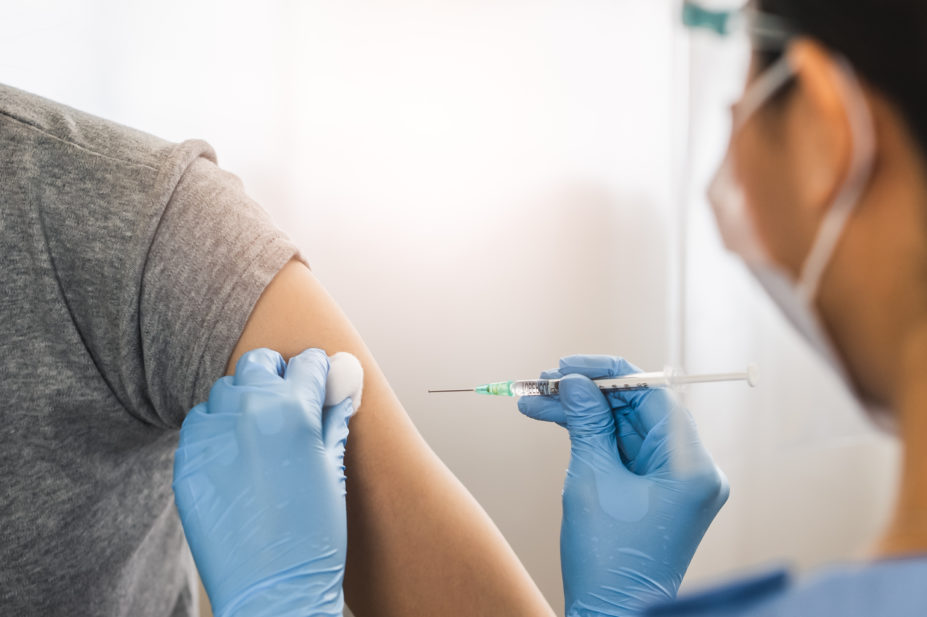 Person administering COVID-19 vaccine