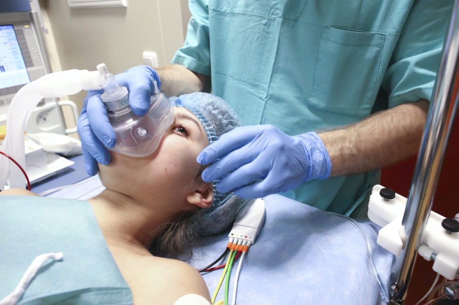 anasethetist preparing patient for surgery