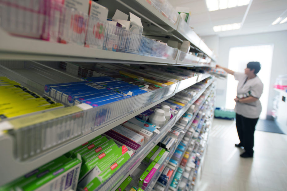 A female pharmacist at work in a pharmacy dispensary