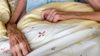 frail female patient lying in bed