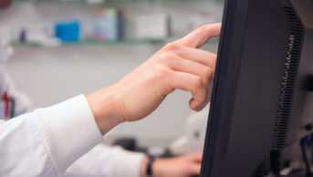 Pharmacist using a computer