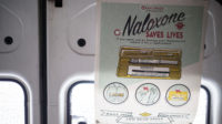 Naloxone poster in a safe consumption van, Glasgow